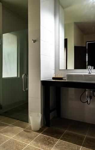 a bathroom with a sink and a mirror at The Hive Hotel in Lamai