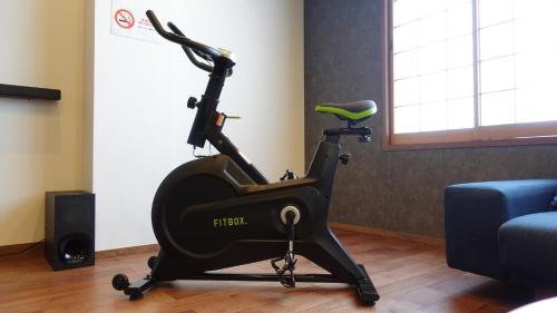 a gym with a exercise bike in a room at Manabi-stay Takayama SAKURA in Takayama