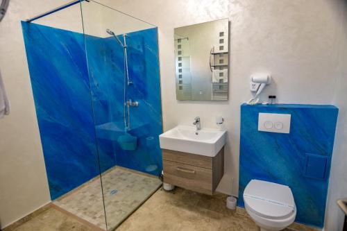 a bathroom with a shower with a sink and a toilet at Blue Border in Vama Veche