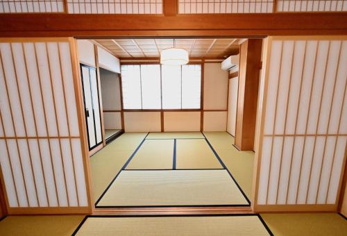 an empty room with a door and a window at Manabi-stay Takayama SAKURA in Takayama