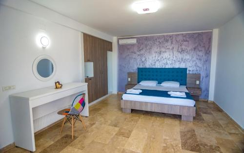 a bedroom with a blue bed and a white fireplace at Blue Border in Vama Veche
