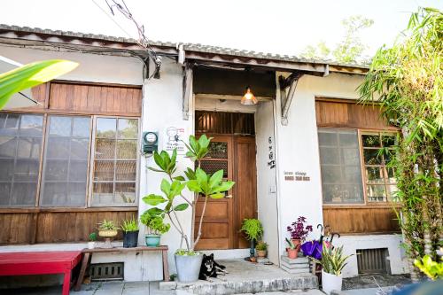 una casa con un gatto seduto fuori di Here Sleep Guesthouse a Kaohsiung