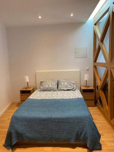 リスボンにあるApartment Beco das Farinhasのベッドルーム1室(青い毛布付きのベッド1台付)