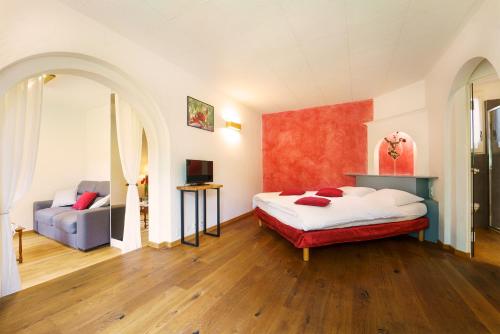 a bedroom with a bed and a couch at Castel de Daval in Sierre
