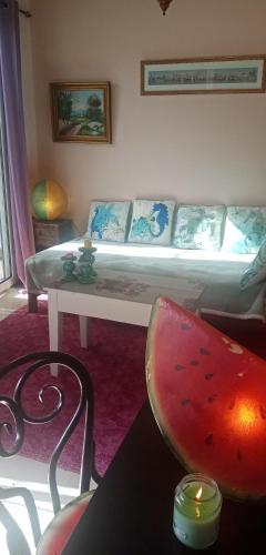 a living room with a couch and a table at Aegina's Flowers house in Aegina Town