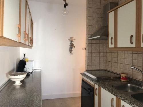 a kitchen with a sink and a counter top at Océano Home in Ayamonte