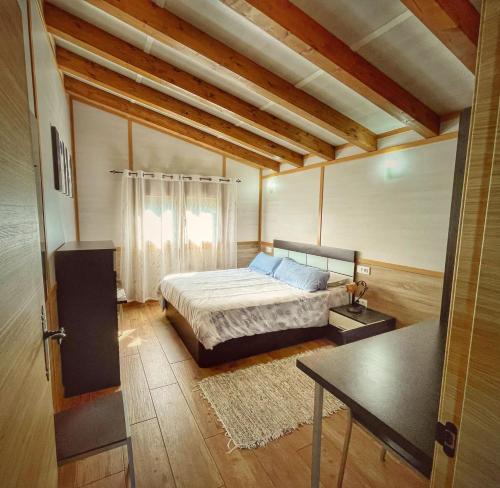 a bedroom with a bed and a table in it at Bungalows Cantia in Suances