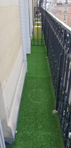 a balcony with green grass on the side of a building at Elysées Union in Paris