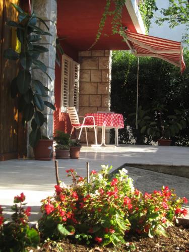 a table and chairs on the porch of a house at Apartment Petrović in Korčula