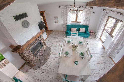 a living room with a table and a fireplace at Chata w Bieszczadzie apartamenty i domki z basenem Bieszczady in Polańczyk