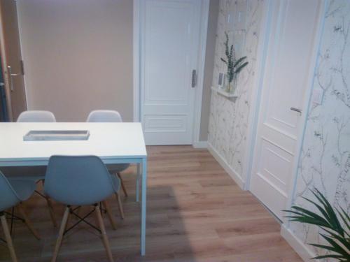 um quarto com uma mesa e cadeiras e uma porta em CASA LAXE DO BARRO em Cangas