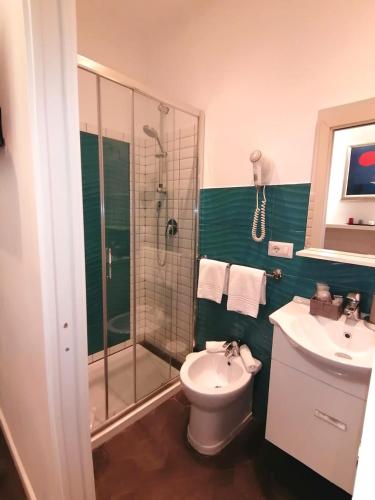 a bathroom with a shower and a toilet and a sink at Residenza Vatican Suite in Rome