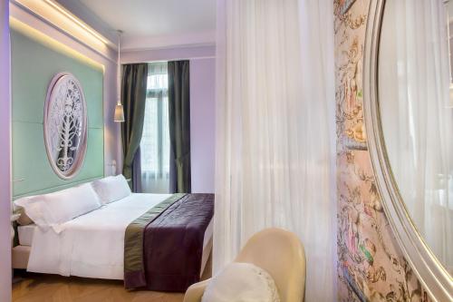 a hotel room with a bed and a mirror at Château Monfort - Relais & Châteaux in Milan