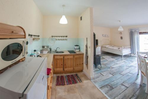 a kitchen with a sink and a living room at Chata w Bieszczadzie apartamenty i domki z basenem Bieszczady in Polańczyk