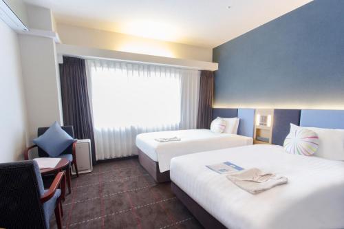 Postel nebo postele na pokoji v ubytování Hearton Hotel Kyoto
