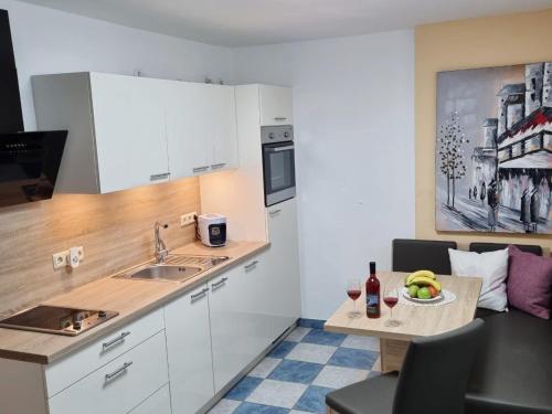 a kitchen with a table with a plate of fruit on it at Ferienwohnung Gerersdorf in Gerersdorf bei Güssing