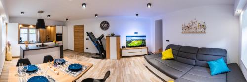 a living room with a couch and a table at Zelena dolina in Cerkno