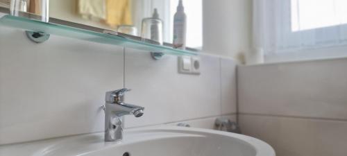 a bathroom with a sink and a mirror at Hotel Seehalde in Nonnenhorn