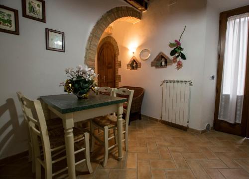 a dining room with a table and chairs at Dimora Tipica Toscana in Monticiano