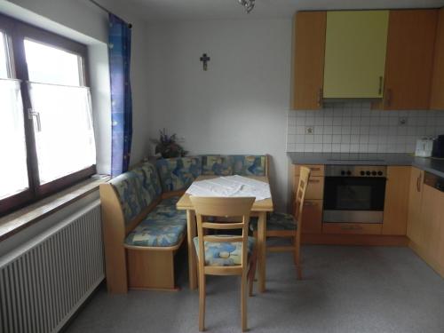 a small kitchen with a table and a couch at Ferienwohnung Schautzgy in Reutte