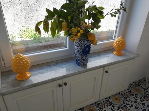 a vase with a plant sitting on a window sill at Villa Dorothee in Capri