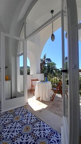 an open door to a patio with a table at Villa Dorothee in Capri