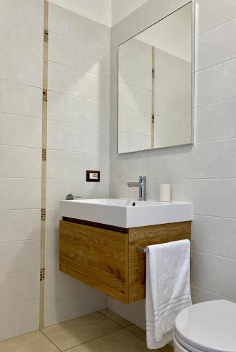 a bathroom with a sink and a mirror at Villa Elia - Tenuta Le Scerze - Salento Homes in Borgagne