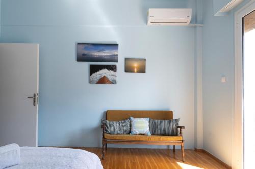 a bedroom with a bed and a wooden bench at Kalamata Art Rooms in Kalamata