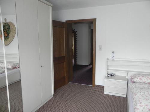 a bedroom with a bed and a closet and a door at Ferienwohnung Schautzgy in Reutte