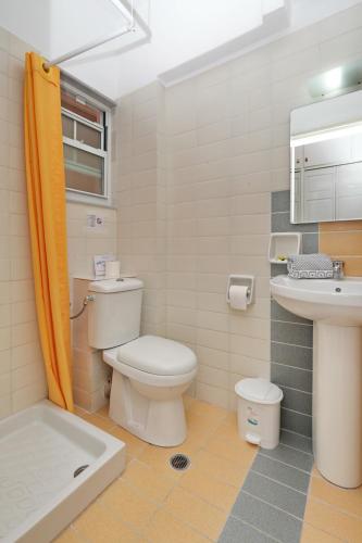 a bathroom with a toilet and a sink at Dolphin Hotel in Skopelos Town