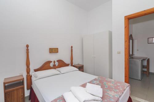 a bedroom with a bed with white towels on it at Dolphin Hotel in Skopelos Town