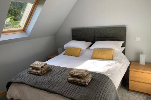 a bedroom with a bed with two towels on it at The Nest - Near Inverness & Loch Ness in Inverness