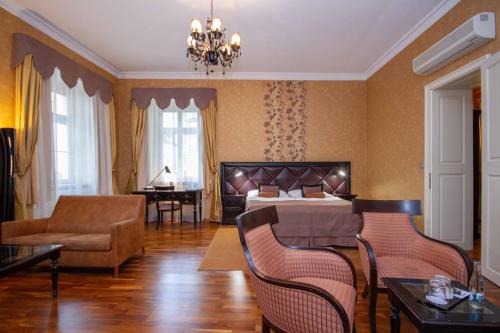 
a living room filled with furniture and a large window at Luxury apartments in the historical building in the heart of Old Town in Bratislava
