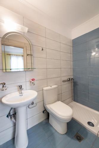 a bathroom with a toilet and a sink and a tub at Mediterraneo studios in Vasiliki