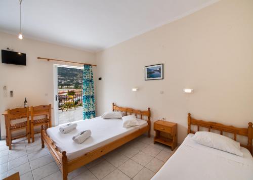 a bedroom with two beds and a window at Mediterraneo studios in Vasiliki