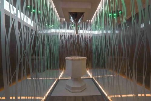 a bathroom with a toilet in a room with lights at Camping Village Cavallino in Cavallino-Treporti
