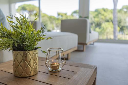 a table with a candle and a potted plant on it at Camping Village Cavallino in Cavallino-Treporti