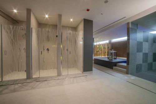 a large bathroom with a shower and a sink at Camping Village Cavallino in Cavallino-Treporti