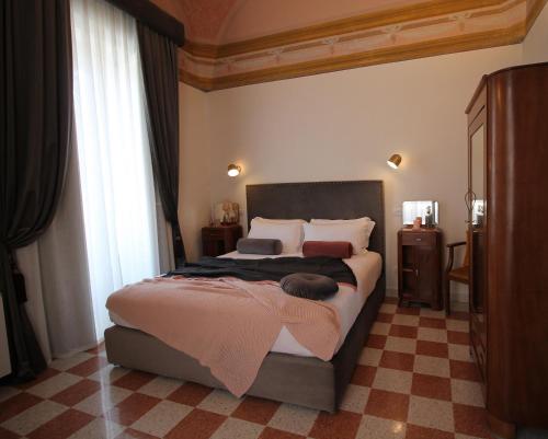 a bedroom with a bed with a pink blanket on it at 1940 Luxury Accommodations by Wonderful Italy in Ostuni