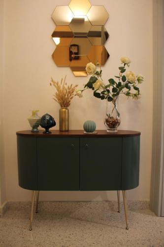 a cabinet with a vase of flowers and a mirror at 1940 Luxury Accommodations by Wonderful Italy in Ostuni