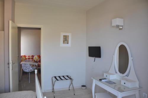 a white room with a vanity and a mirror at Sirene Villas in Dhiakofti