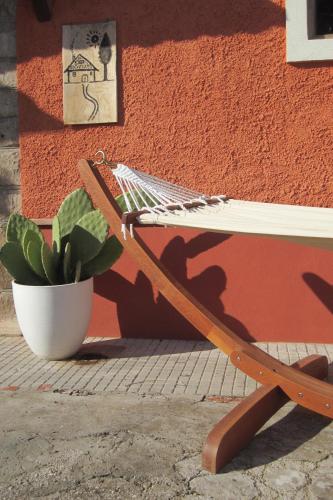 a bench next to a plant next to a wall at B&B Tobia in Cave