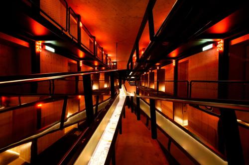 a long hallway with red lights in a building at Zero Box Lodge Coimbra in Coimbra