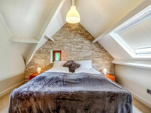 a bedroom with a large bed in a attic at Alterbiezen in Hoeselt