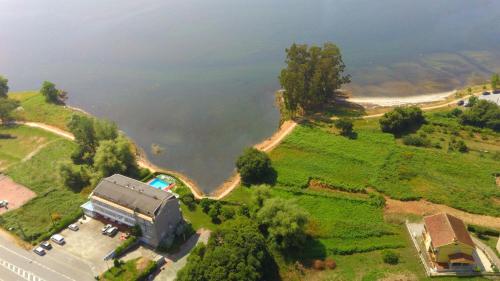 an aerial view of a house next to a lake at Las Islas in Vilaboa