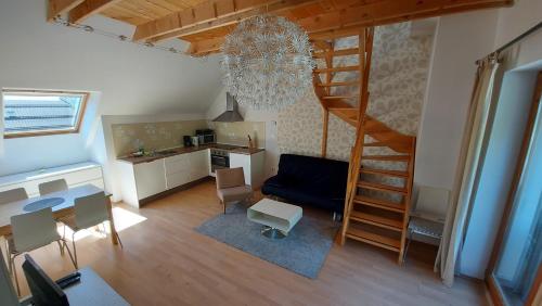 a living room with a spiral staircase and a kitchen at Apartments Supermjau in Bovec