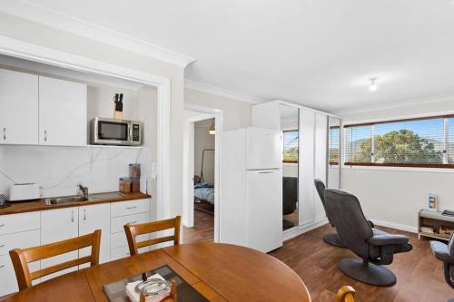 a kitchen and dining room with a table and chairs at Hillview, a quiet country escape with views. in Yangan