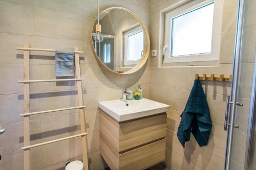 a bathroom with a sink and a mirror at Positive sport apartments in Kobarid