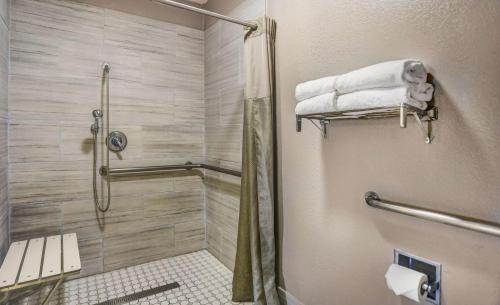 a bathroom with a shower and a toilet and towels at Motel 6-Lodi, CA in Lodi