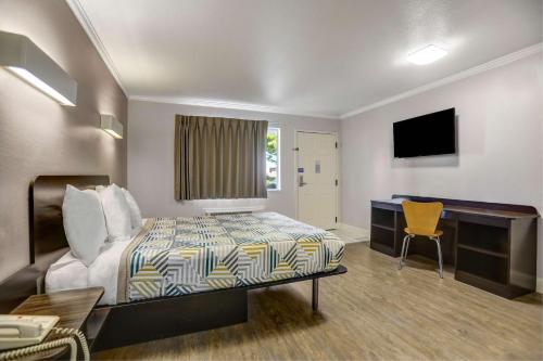 a hotel room with a bed and a desk at Motel 6-Lodi, CA in Lodi